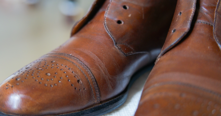 A close up of a pair of brown shoes