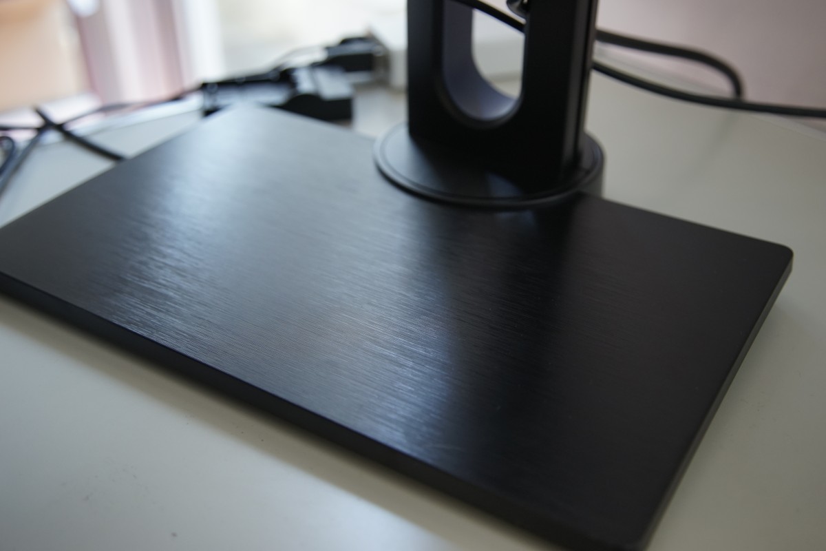 A black computer mouse on a desk